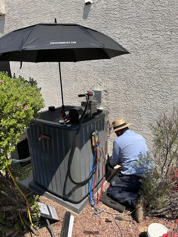 HVAC technician performing outdoor AC maintenance in Southgate